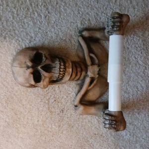 Spooky skull toilet paper holder.